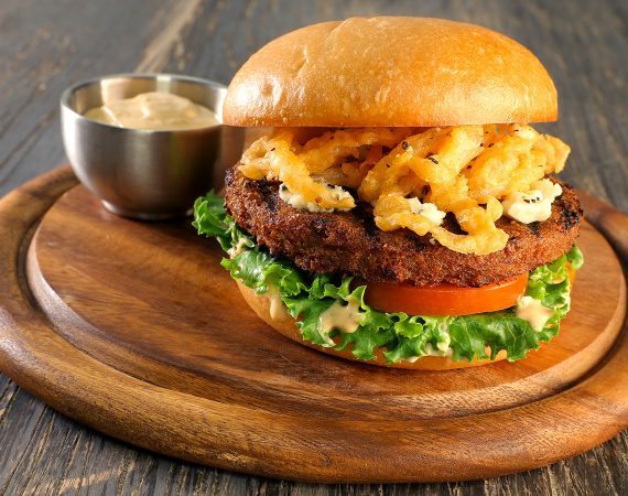 Plant-based burger on a bun with fried onions
